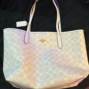 Large white and off-white Coach purse. Burgundy inside.
